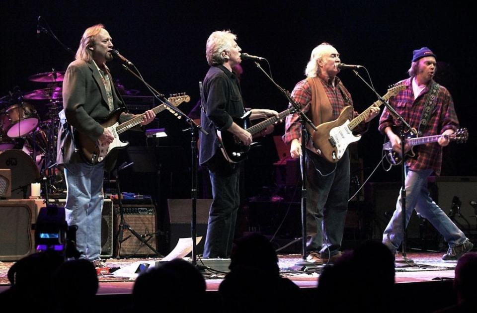 Stephen Stills, (L) Graham Nash (2nd L), David Crosby (2nd R) and Neil Young (R) perform in Auburn Hills, Michigan, on Jan. 24, 2000.