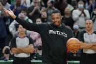 Former Boston Celtics player Paul Pierce gestures to the crowd as he comes onto the court during a ceremony before an NBA basketball game against the Toronto Raptors, Friday, Oct. 22, 2021, in Boston. (AP Photo/Michael Dwyer)