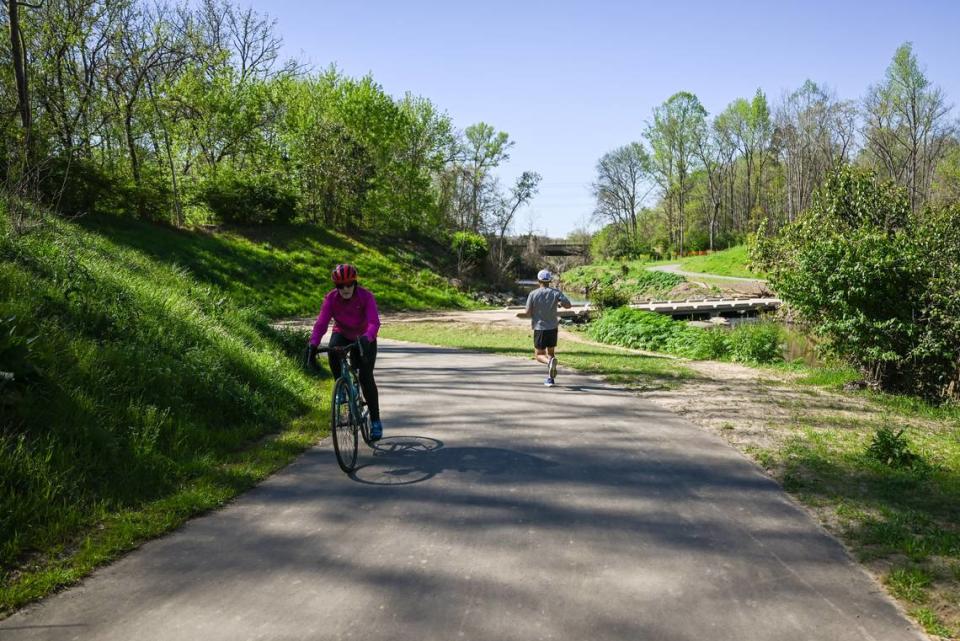 Théoden Janes passes a cyclist as he nears Tyvola Road while heading south on Little Sugar Creek Greenway.