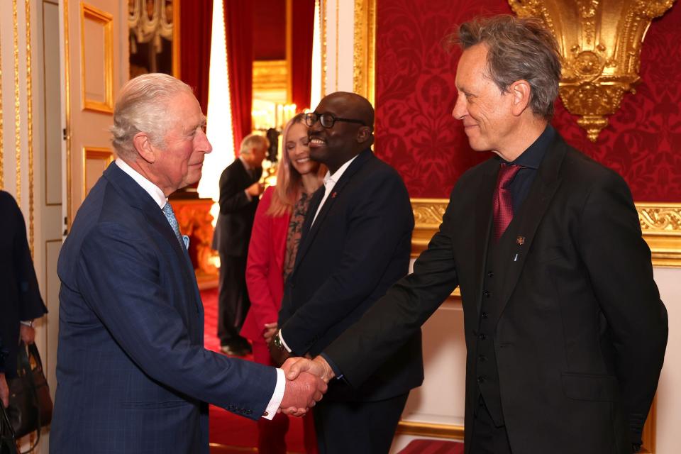 Prince Charles, Prince of Wales shakes hands with Richard E. Grant during the Prince's Trust Awards Trophy Ceremony at St James Palace on October 21, 2021 in London, England.