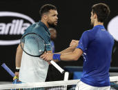 Serbia's Novak Djokovic, right, is congratulated by France's Jo-Wilfried Tsonga after winning their second round match at the Australian Open tennis championships in Melbourne, Australia, Friday, Jan. 18, 2019.(AP Photo/Aaron Favila)