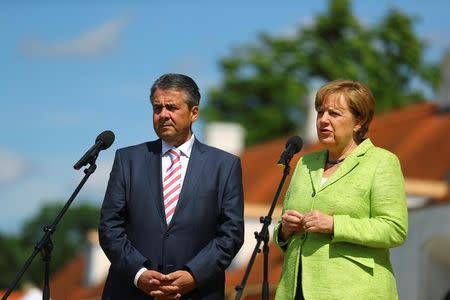 German Chancellor Angela Merkel and Vice Chancellor Sigmar Gabriel brief the media prior to a meeting with German government's Social Partners, leaders of labor unions and employer organizations, at the government guest house Meseberg Palace, Germany, June 14, 2017. REUTERS/Hannibal Hanschke/Files