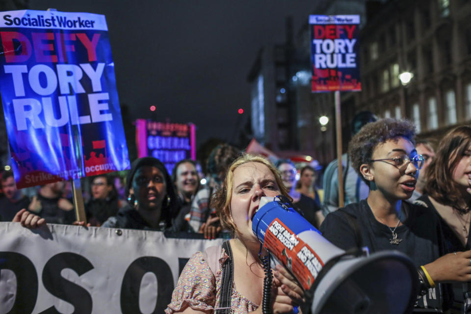 Protesters outside the House of Commons, London, Tuesday, Sept. 3, 2019. British Prime Minister Boris Johnson suffered key defections from his party Tuesday, losing a working majority in Parliament and weakening his position as he tried to prevent lawmakers from blocking his Brexit plans. (AP Photo/Vudi Xhymshiti)