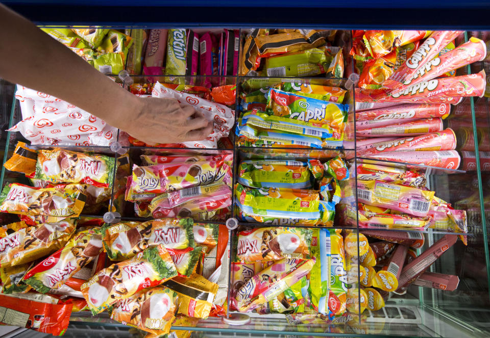 A visitor grabs Langnese ice cream in Heppenheim, Germany, 06 August 2013. Europe's largest ice cream factory, which belongs to the Unilever Group, produces ice cream in three layers and six days a week. Photo: FRANK RUMPENHORST | usage worldwide   (Photo by Frank Rumpenhorst/picture alliance via Getty Images)