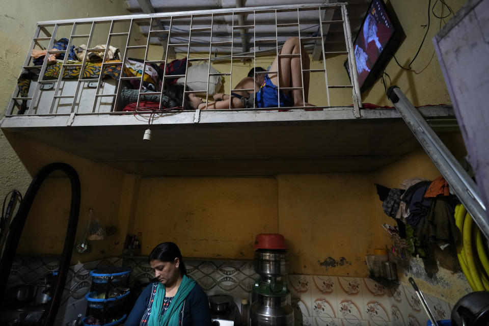 Sheela Singh, 39, inside her house in a shanty area in Mumbai, India, Sunday, March 19, 2023. When she resigned in 2020 because of pressure from family, her monthly salary was higher than her husband's, an auto-rickshaw driver whose earnings fluctuated every day — but no one ever suggested he quit. Living in Mumbai on a single salary however has proved too expensive and Singh is now preparing to move back to the village where she once migrated from to live with her parents and enroll her children in school there. (AP Photo/Rajanish Kakade)