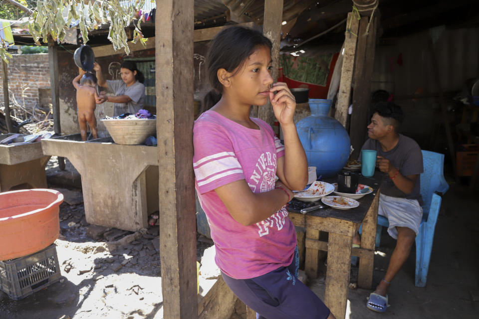 Tatiana Mendoza, 17, waits for her grandmother's return, while her cousins carry out other activities in the house where she lives now because her parents were detained during the government's crackdown on its war against drugs, in Santa Ana, El Salvador, Wednesday, Jan. 31, 2024. Forty thousand children have seen one parent or both detained in President Nayib Bukele’s nearly two-year war on El Salvador's gangs, according to El Salvador’s social services entity. (AP Photo/Salvador Melendez)