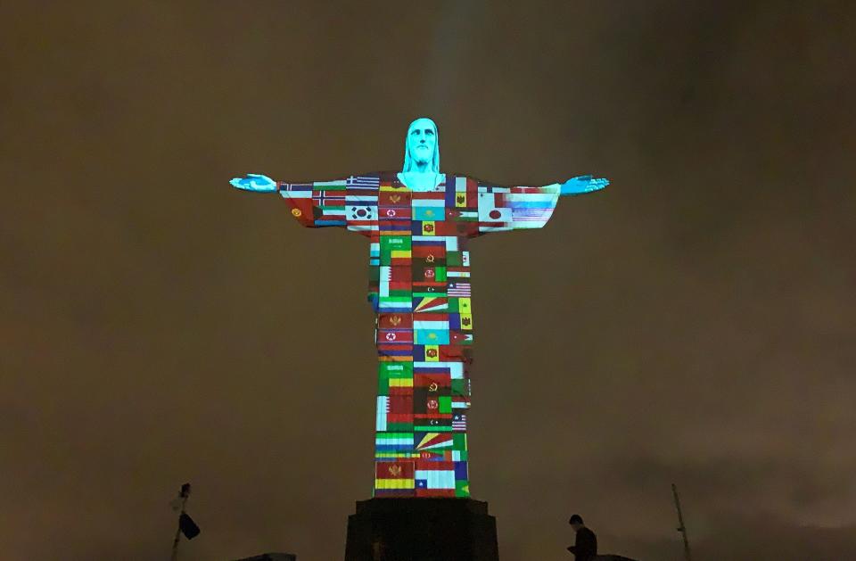 Flags of the countries affected by the spread of the new coronavirus are projected on the Christ the Redeemer statue in Rio de Janeiro on March 18, 2020. (Photo: FLORIAN PLANCHEUR via Getty Images)