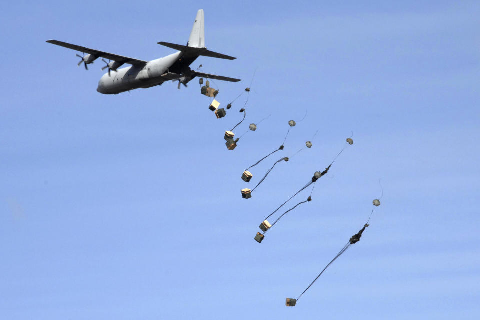 In this photo provided by the Australian Defence Force, an AC-130 Hercules aircraft drops packages near Richmond, Australia, Aug. 22, 2007. Australia said Monday, July 24, 2023, it will buy 20 new C-130 Hercules from the United States in a 9.8 billion Australian dollar ($6.6 billion) deal that will increase by two-thirds the size of the Australian air force’s fleet of its second-largest heavy transport aircraft. (ADF via AP)