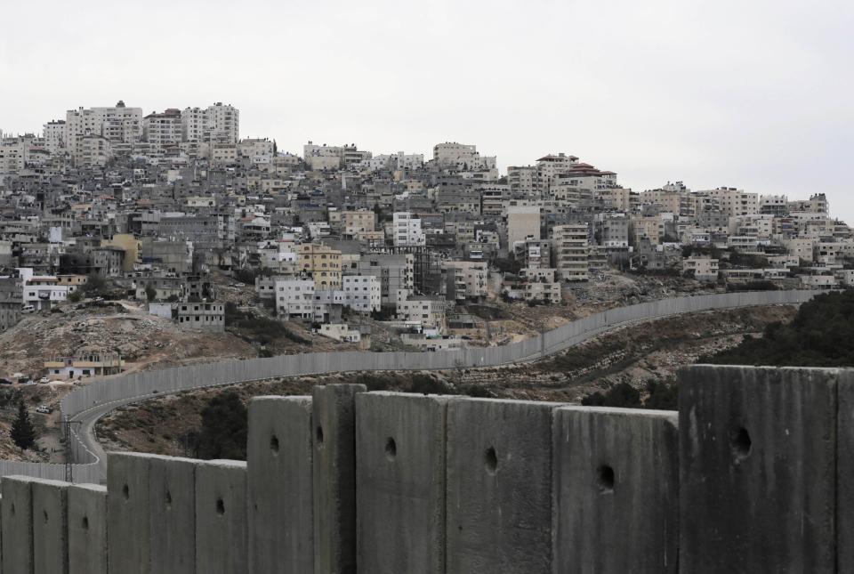 Israel's controversial barrier runs along the Shuafat refugee camp in the West Bank near Jerusalem