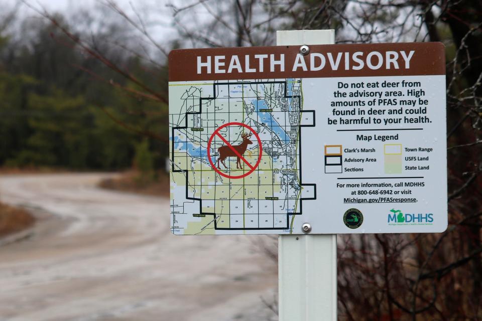 This photo provided by the National Wildlife Federation shows a sign warning hunters not to eat deer because of high amounts of toxic chemicals in their meat, in Oscoda, Mich., on March 26, 2021. Wildlife agencies in some parts of the country are finding elevated levels of PFAS chemicals in game animals such as deer, prompting new restrictions on hunting and fishing.