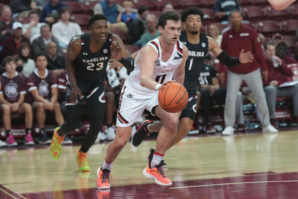 Nov 18, 2022; Charleston, South Carolina, USA; Davidson Wildcats guard Foster Loyer (0) drives the ball in the second half against the South Carolina Gamecocks at TD Arena.