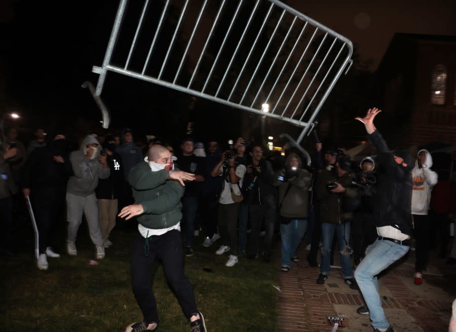 LOS ANGELES, CALIFORNIA – May 1: Pro-Palestinian protestors and pro-Israeli supporters clash at an encampment at UCLA early Wednesday morning. (Wally Skalij/Los Angeles Times via Getty Images)