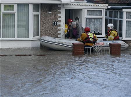 Emergency services rescue people from a flooded properties in Rhyl, north Wales December 5, 2013. REUTERS/Phil Noble