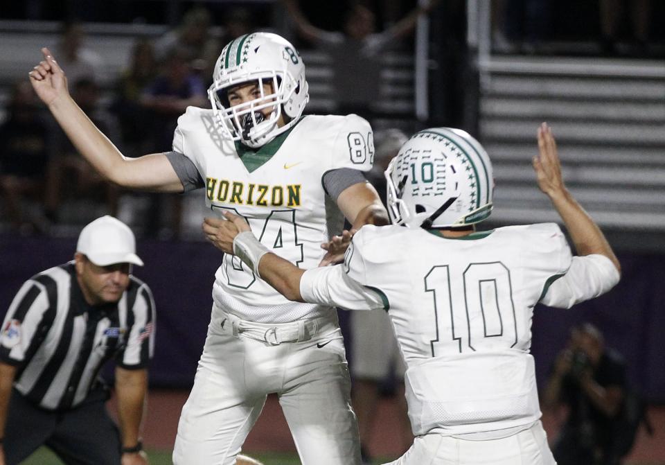 Horizon kicker Grady Gross (84) and Jake MartinelliÊ(10) celebrate their overtime win over Norte Dame Prep's during their game in Scottsdale, Friday, Oct. 11, 2019.