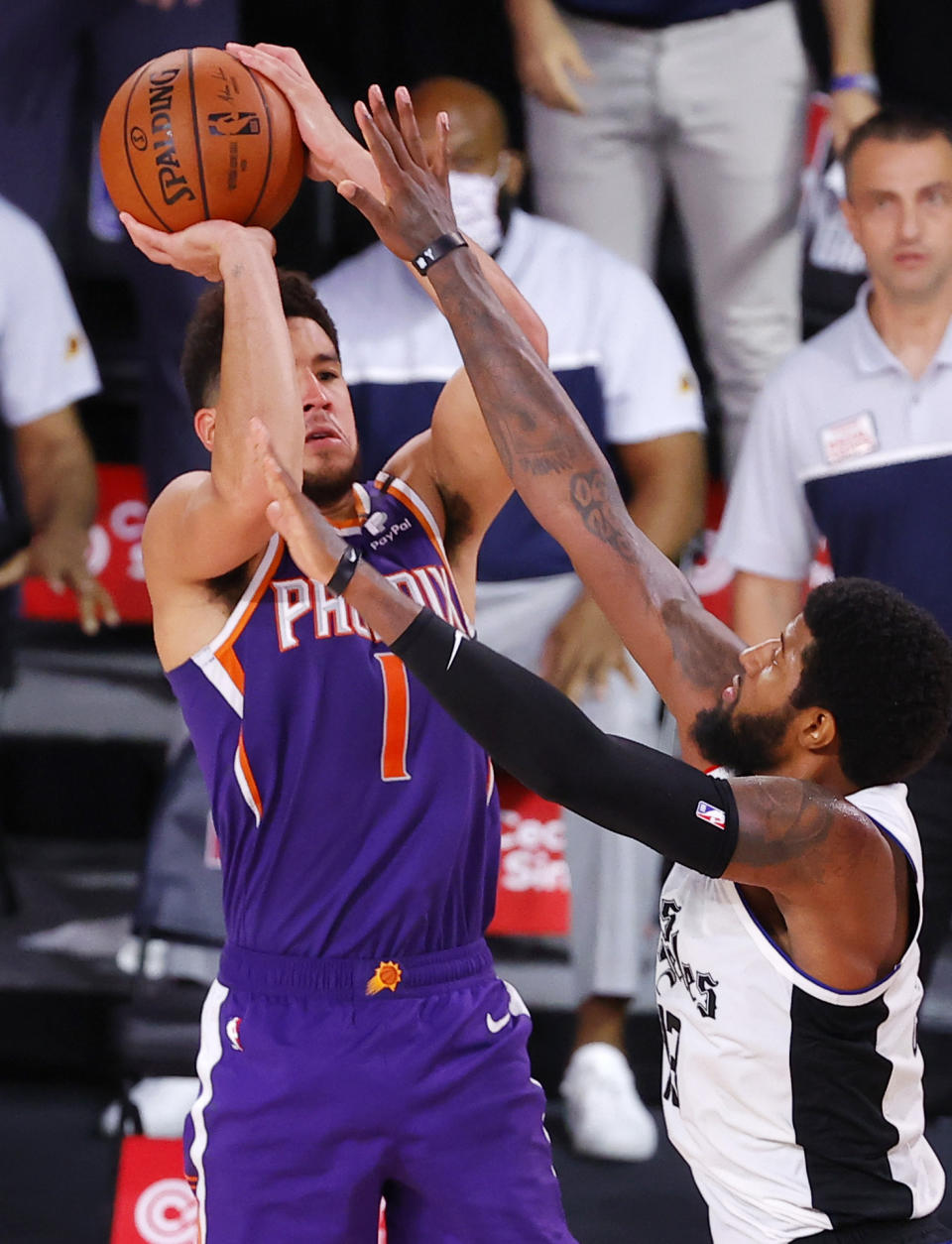 Phoenix Suns' Devin Booker shoots the game-winning basket over Los Angeles Clippers' Paul George in an NBA basketball game Tuesday, Aug. 4, 2020, in Lake Buena Vista, Fla. (Kevin C. Cox/Pool Photo via AP)