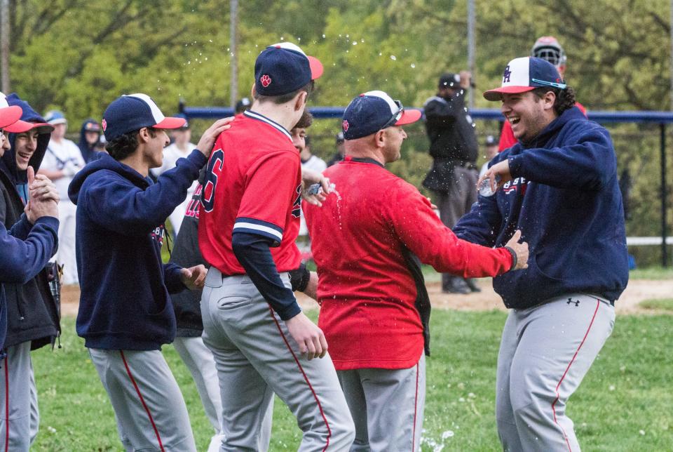 Byram Hills players shower coach Scott Saunders with water bottles in celebration of the longtime coach's 200th career win on Monday, May 1, 2023.