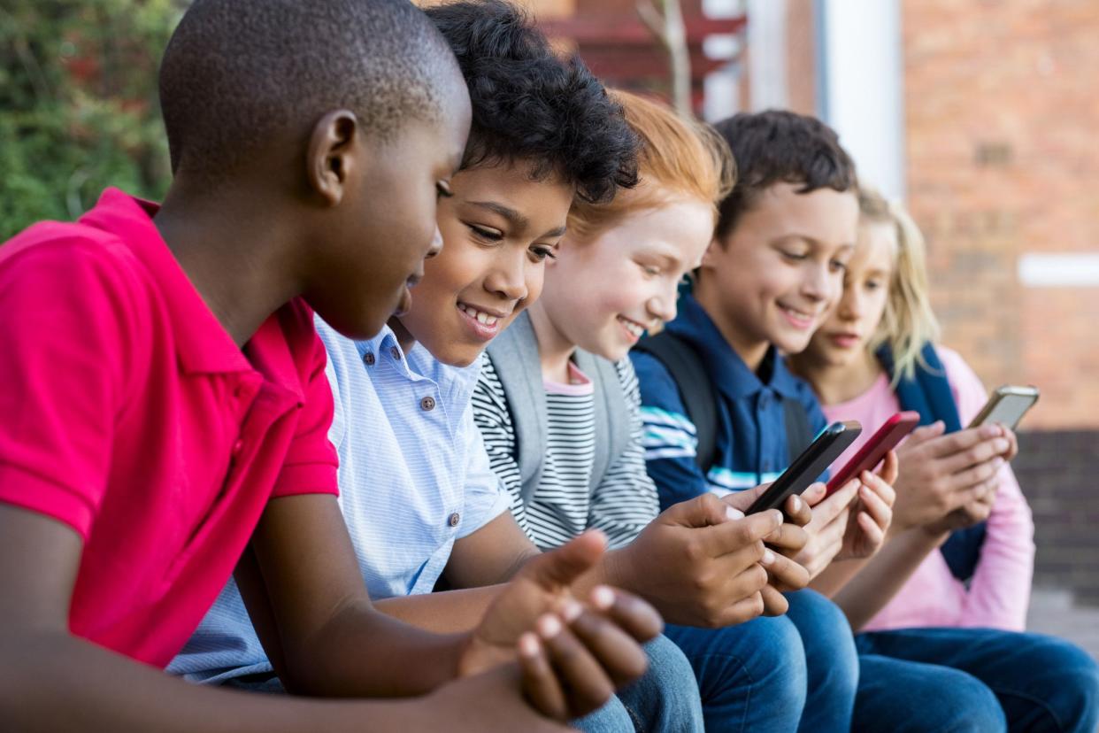 pupils using mobile phone at the elementary school during recreation time