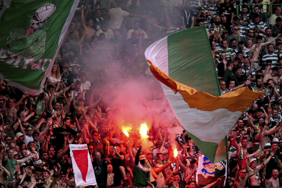 Celtic fans let off smoke flares, during the Scottish Premiership soccer match between Glasgow Rangers and Celtic Glasgow, at the Celtic Park, in Glasgow, Scotland, Saturday May 11, 2024. (Jane Barlow/PA via AP)