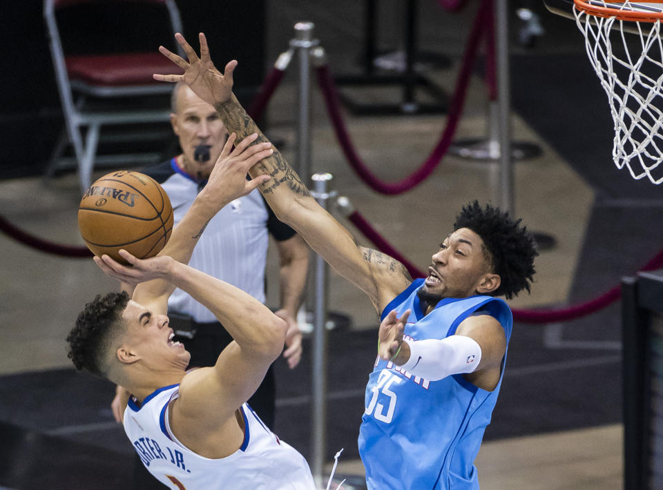 Denver Nuggets forward Michael Porter Jr. (1) tries to shoot over Houston Rockets center Christian Wood (35) during the third quarter of an NBA basketball game Friday, April 16, 2021, in Houston. (Mark Mulligan/Houston Chronicle via AP)