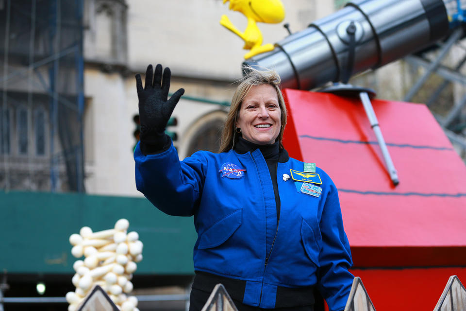 Decorated astronaut Kay Hire waves to crowds on Snoopy’s Doghouse from Peanuts Worldwide Float in the 93rd Macy’s Thanksgiving Day Parade. (Photo: Gordon Donovan/Yahoo News)