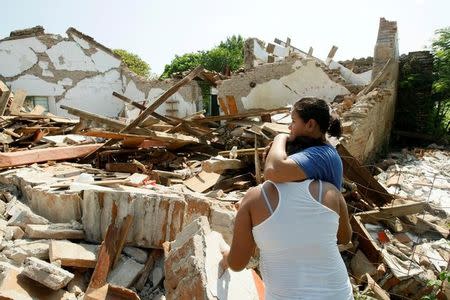 Women hug while standing next to a destroyed house after an earthquake struck the southern coast of Mexico late on Thursday, in Union Hidalgo, Mexico September 9, 2017. REUTERS/Jorge Luis Plata