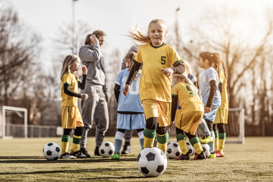 Little girl playing football