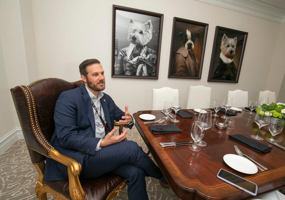 Justin Garner, director of hospitality operations, sits in the private dinning room at Stirrups, an upscale steak restaurant in the hotel at the World Equestrian Center.