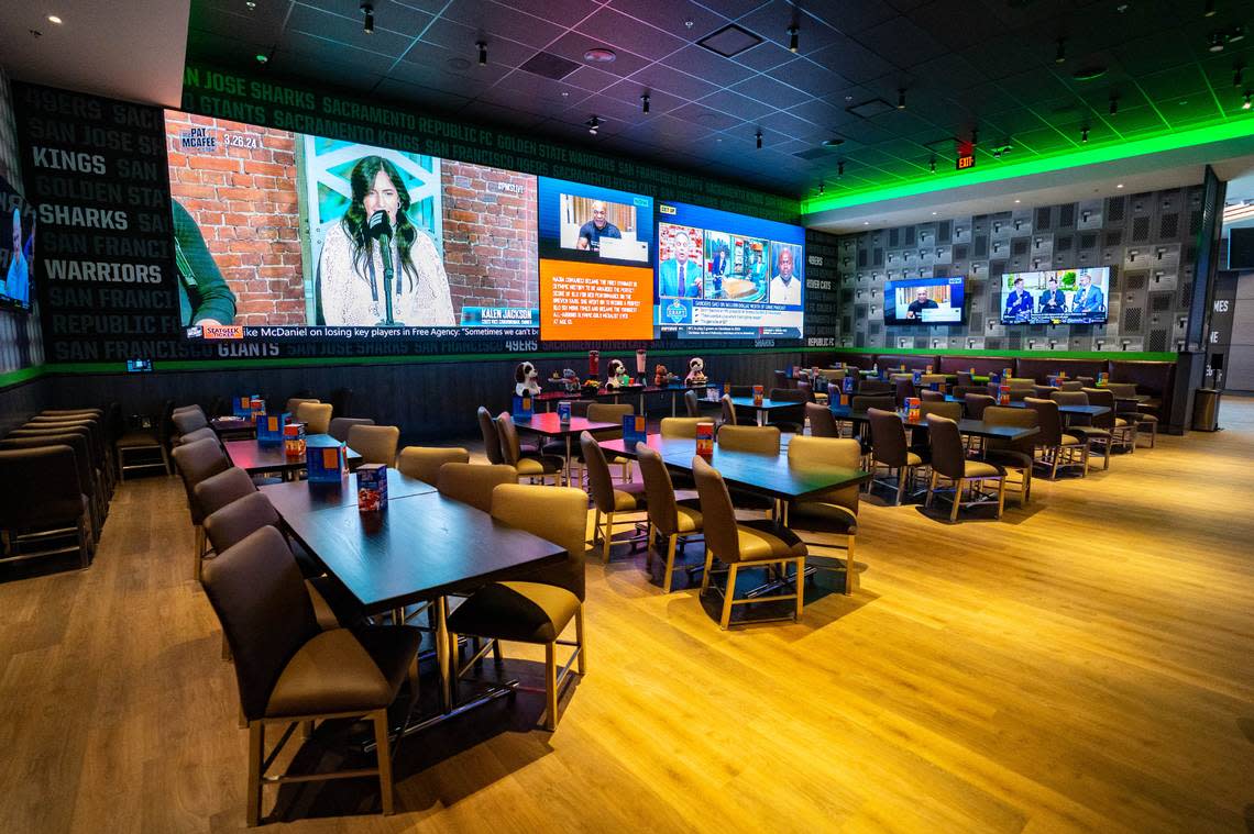 The dining area of Dave & Buster’s features a 60-foot Wow Wall screen, Tuesday, March 26, 2024. Cameron Clark/cclark@sacbee.com