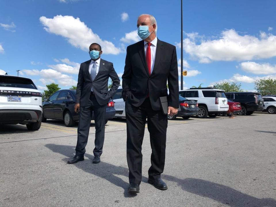 Miami-Dade Mayor Carlos Gimenez, foreground, at a May 4, 2020, press conference on a new coronavirus testing site with Commissioner Jean Monestime. On June 17, 2020, Gimenez linked a spate of worsening coronavirus statistics to people not wearing masks in stores and restaurants, as well as recent outdoor protests. 