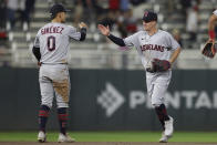 Cleveland Guardians' Andres Gimenez (0) high-fives Myles Straw, right, after defeating the Minnesota Twins during the 10th inning of a baseball game Saturday, May 14, 2022, in Minneapolis. (AP Photo/Stacy Bengs)