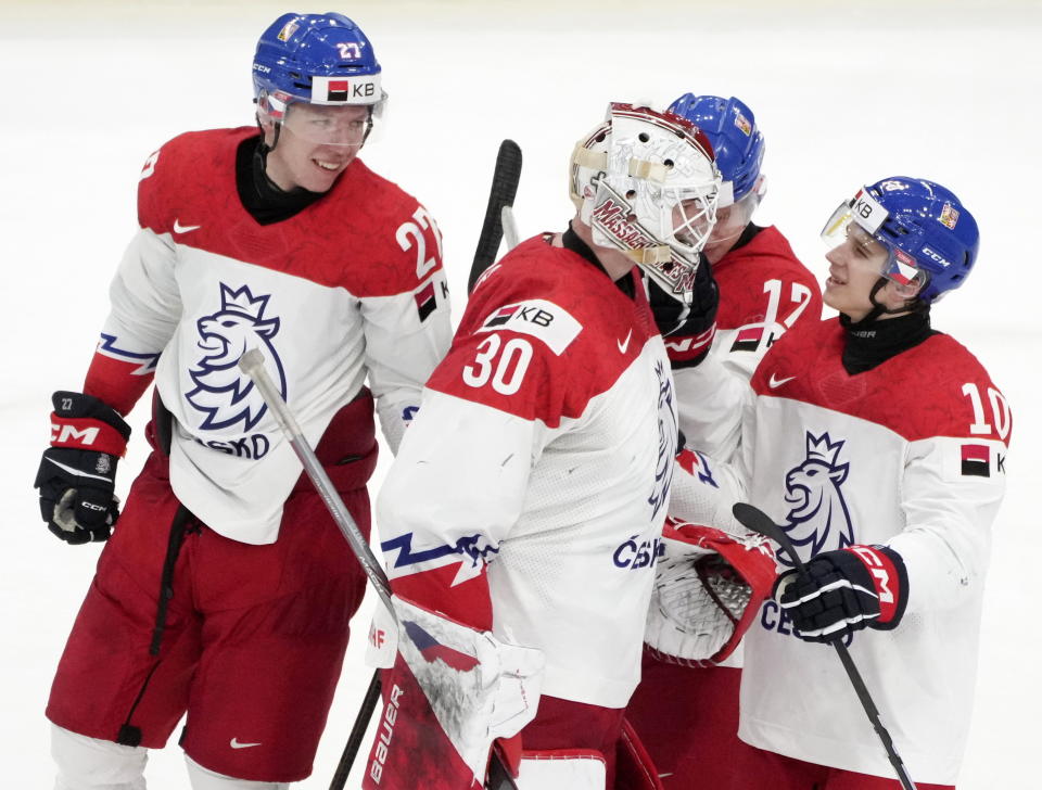 Czechia goaltender Michael Hrabal (30) celebrates with teammates Marek Alscher (27), Sebastian Redlich (17) and Adam Bares (10) following their win over Canada in a quarterfinal match at the IIHF World Junior Hockey Championship in Gothenburg, Sweden, Tuesday, Jan. 2, 2024. (Christinne Muschi/The Canadian Press via AP)