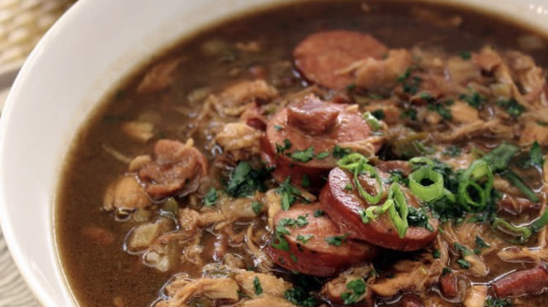 Bowl of gumbo with sausage and greens