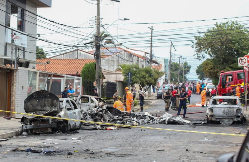 Wrecked cars are seen at the site where a small plane crashed on a residential street in Belo Horizonte