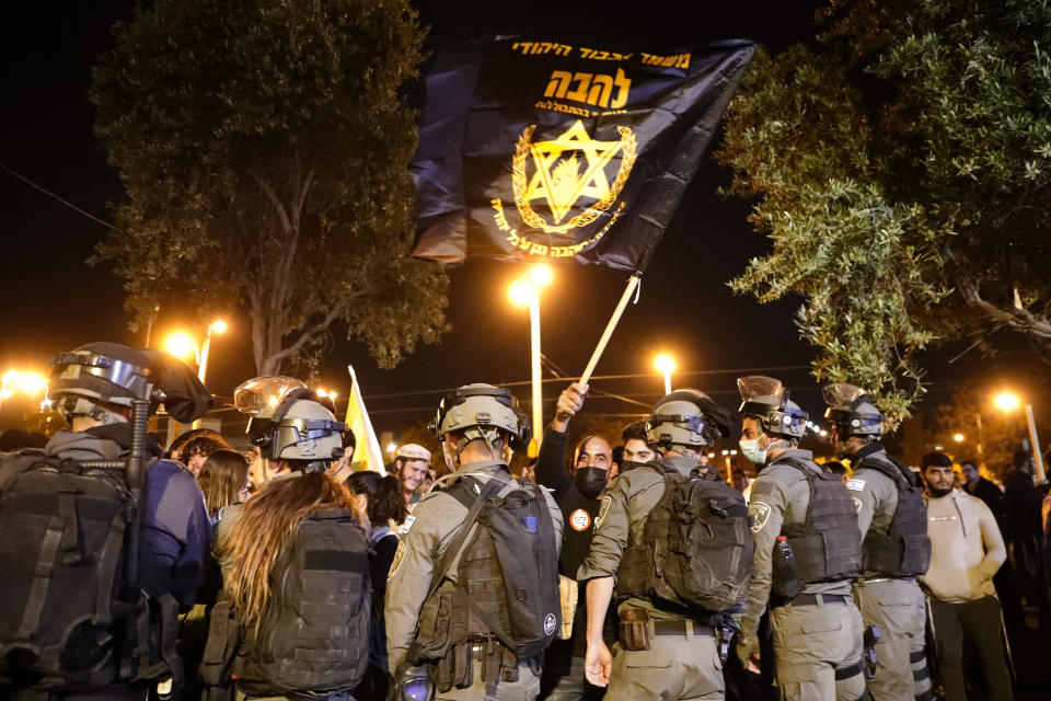 Israeli border police block members of "Lahava", a Jewish extremist group, to approach to Damascus Gate to protest amid heightened tensions in the city, just outside Jerusalem's Old City, Thursday, April. 22, 2021. (AP Photo/Ariel Schalit)