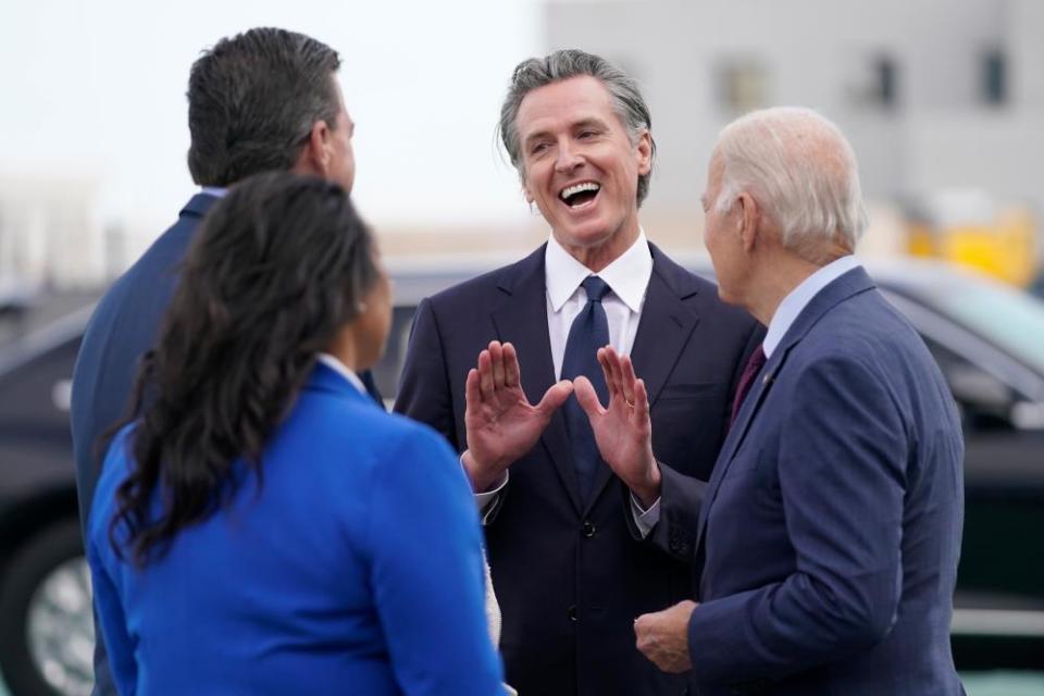 President Joe Biden talks with California governor Gavin Newsom as he arrives at San Francisco International Airport for the Apec summit.