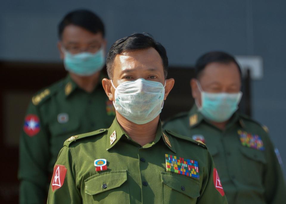 The military-appointed members of parliament wearing face masks amid fears about the spread of the COVID-19 novel coronavirus leave after a session in Naypyidaw on March 4, 2020. - Myanmars military dominates the country's politics, holding a quarter of seats in parliament and controlling three ministries. (Photo by Thet Aung / AFP) (Photo by THET AUNG/AFP via Getty Images)