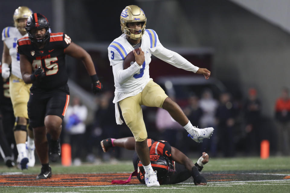 UCLA quarterback Dante Moore (3) slips a tackle by Oregon State linebacker Easton Mascarenas-Arnold (5) during the first half of an NCAA college football game Saturday, Oct. 14, 2023, in Corvallis, Ore. (AP Photo/Amanda Loman)