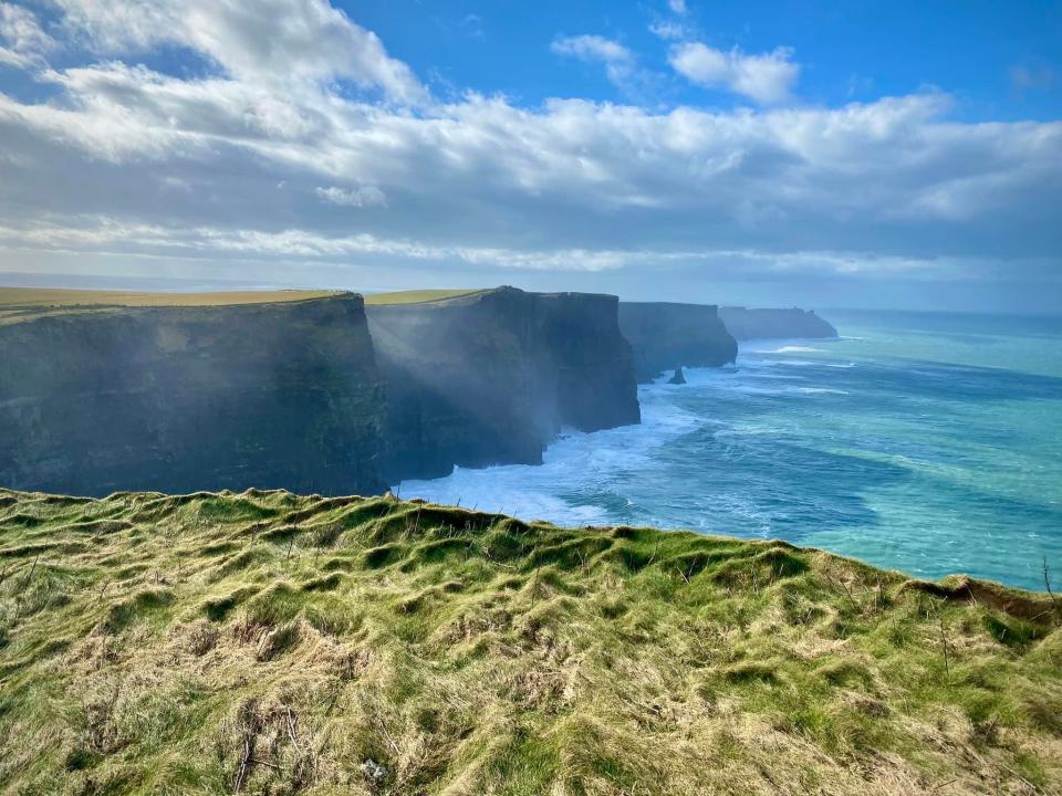 clouds rolling over the cliffs of moher in ireland