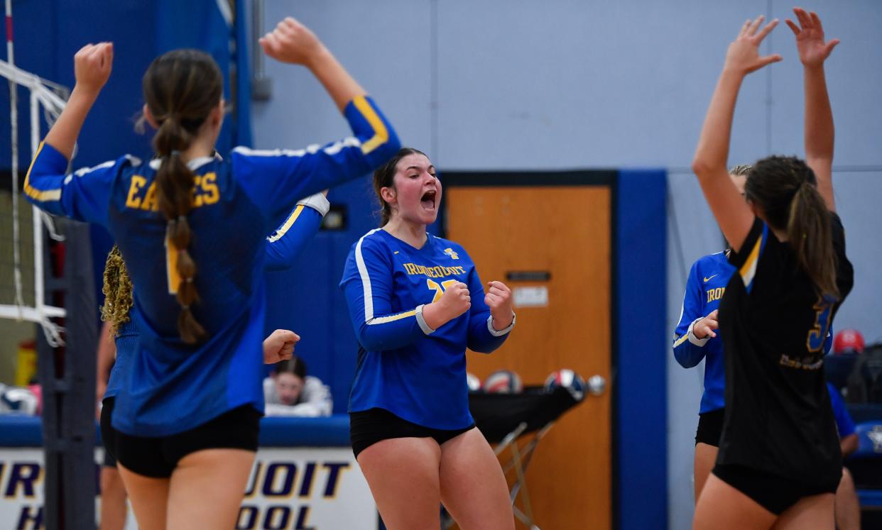 Irondequoit's Laney Flynn, center, celebrates with teammates after a point during a regular season game against Pittsford Mendon, Friday, Sept. 22, 2023.
