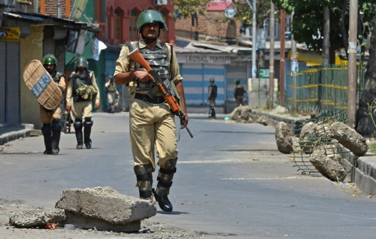 An Indian paramilitary trooper patrols during a curfew in downtown Srinagar on July 24, 2016