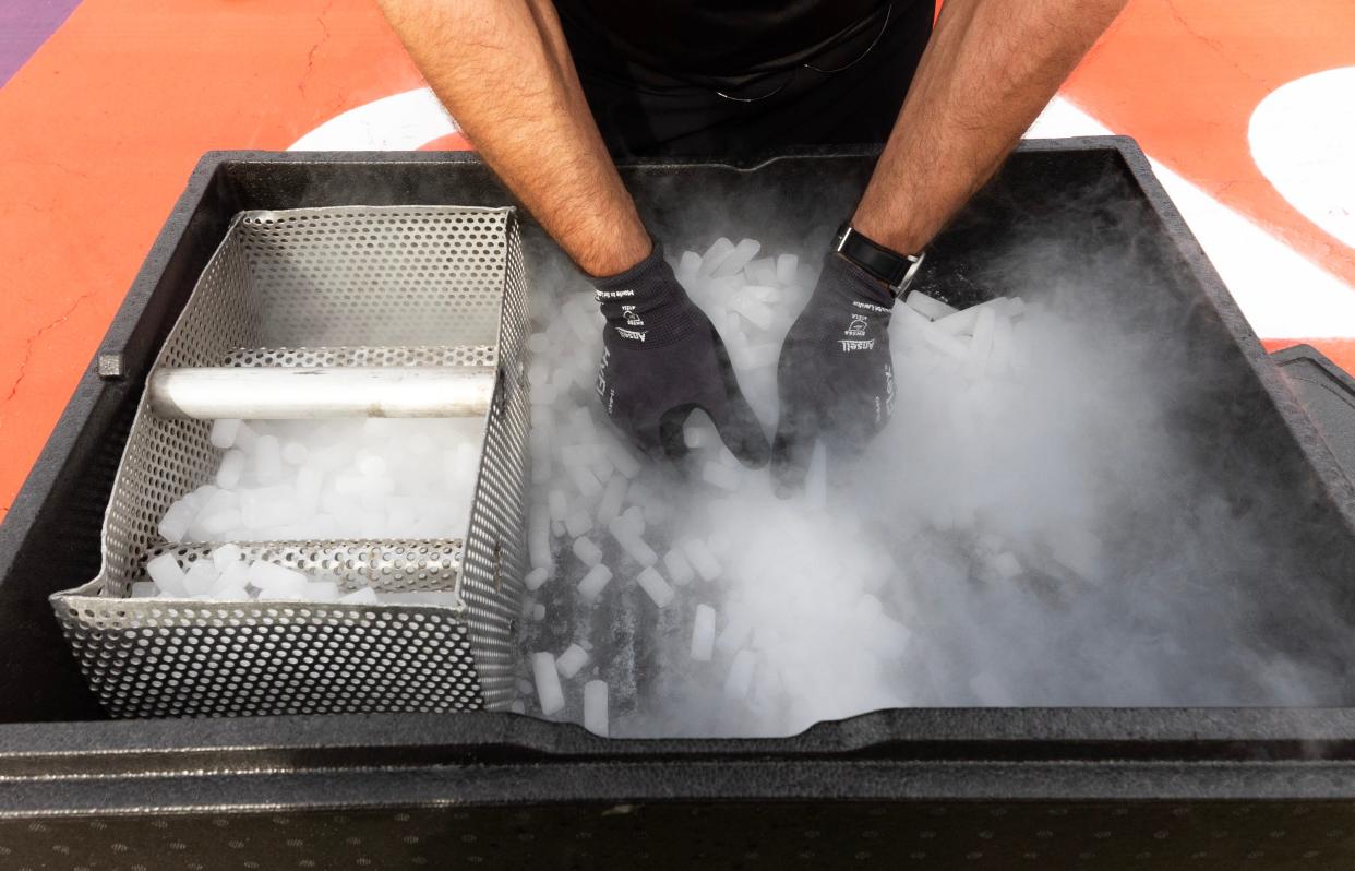 A mechanic prepares dry ice to cool an engine down during the Sprint Race of the 2023 United States Grand Prix in Austin, Texas, Oct 21, 2023.