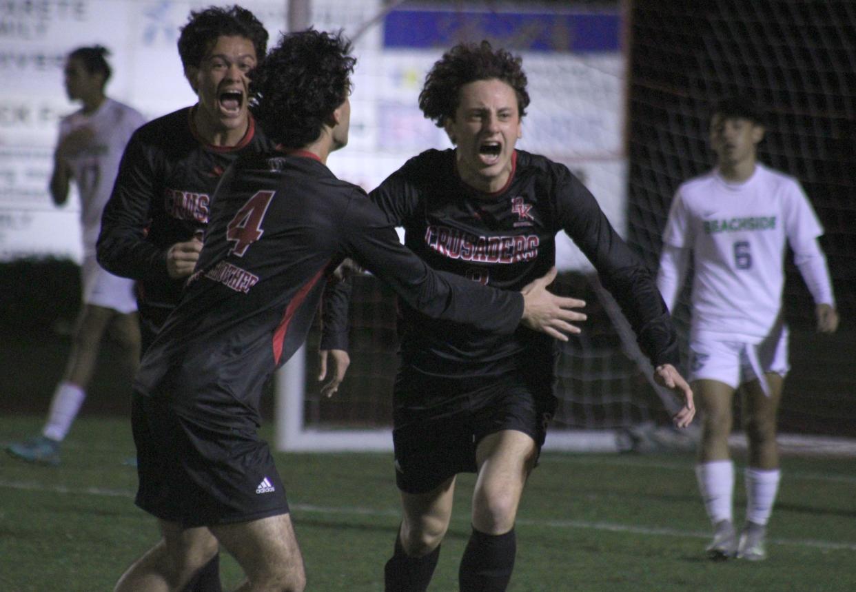 Bishop Kenny forward Joseph Jimenez (8) celebrates his go-ahead goal with teammates during  an FHSAA Region 1-4A boys soccer semifinal against Beachside on February 13, 2023. [Clayton Freeman/Florida Times-Union]