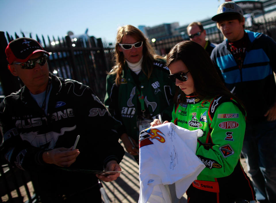 FORT WORTH, TX - NOVEMBER 04: Danica Patrick, driver of the #7 GoDaddy.com/DanWheldonMemorial.com Chevrolet in the Nationwide Series, signs an autograph during practice for the NASCAR Sprint Cup Series AAA Texas 500 at Texas Motor Speedway on November 4, 2011 in Fort Worth, Texas. "I've been describing it as the first day of the rest of my life," Patrick said of her upcoming full-time move to NASCAR. (Photo by Tom Pennington/Getty Images for NASCAR)