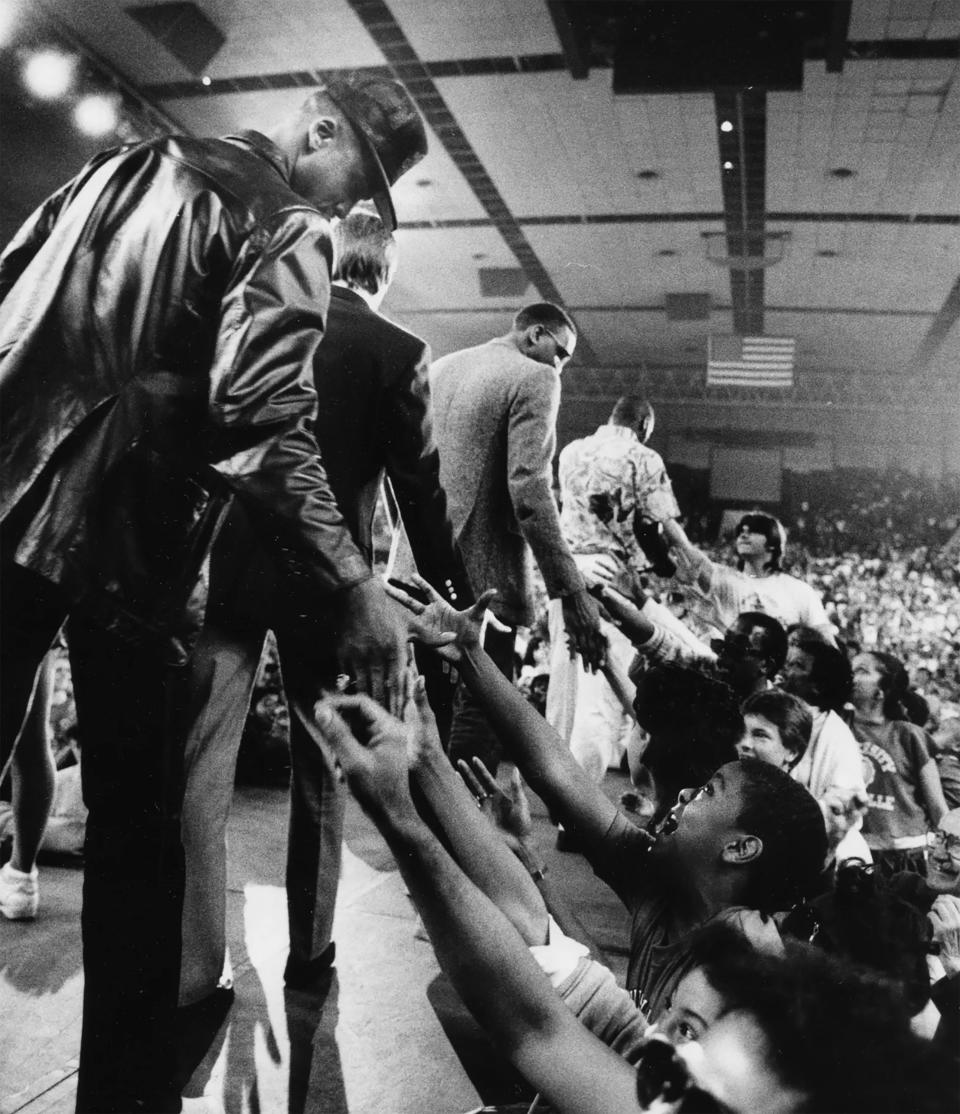 Milt Wagner, left, and other members of the U of L team greeted fans at the end of last night's NCAA Championship celebration at Freedom Hall. April 1, 1986