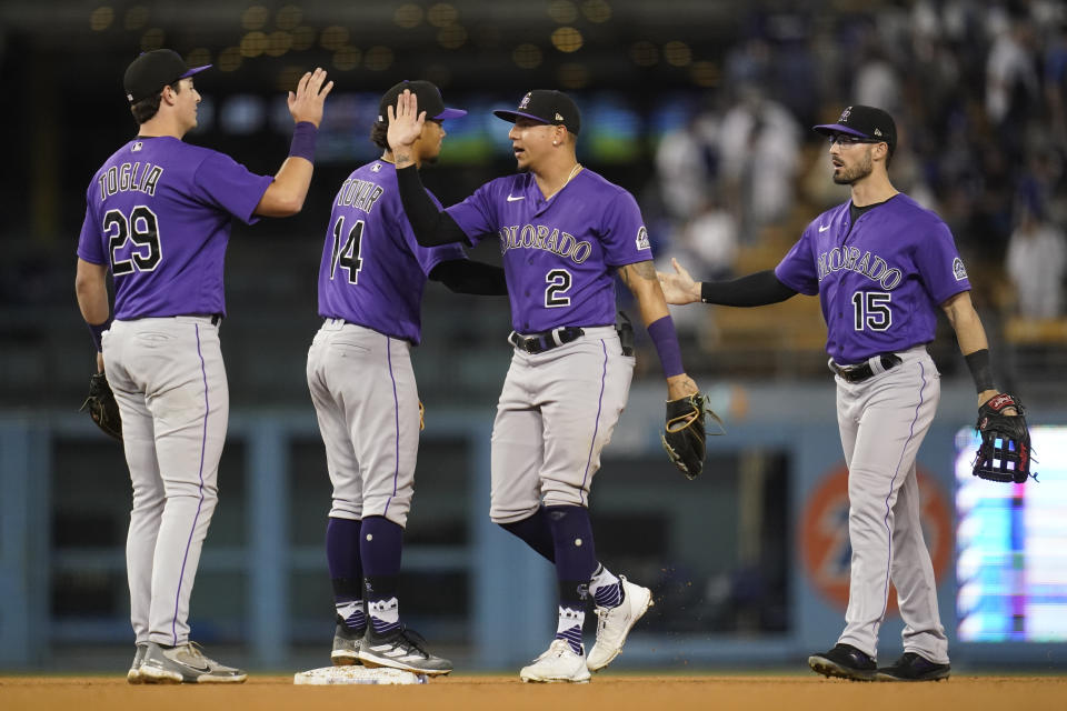 The Colorado Rockies celebrate after a 2-1 win over the Los Angeles Dodgers in a baseball game in Los Angeles, Monday, Oct. 3, 2022. (AP Photo/Ashley Landis)