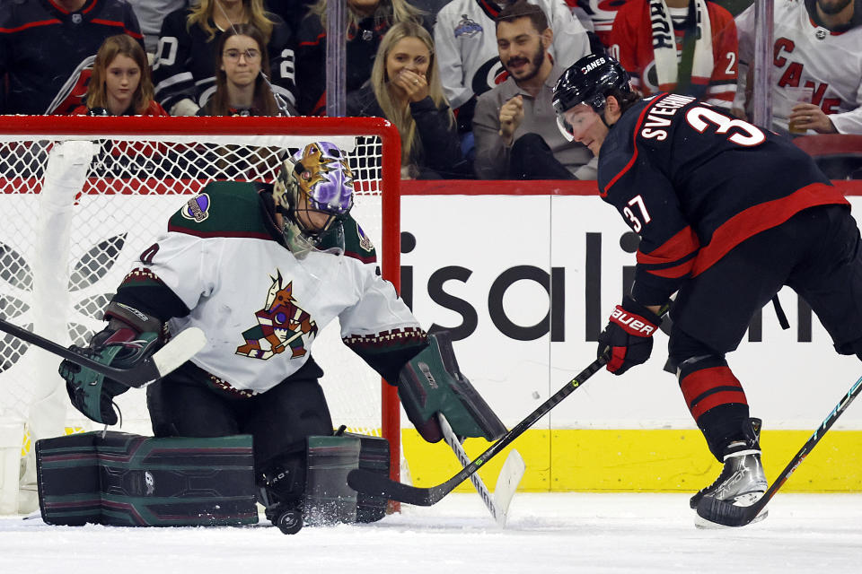 Arizona Coyotes goaltender Karel Vejmelka (70) blocks the shot of Carolina Hurricanes' Andrei Svechnikov (37) during the first period of an NHL hockey game in Raleigh, N.C., Wednesday, Nov. 23, 2022. (AP Photo/Karl B DeBlaker)