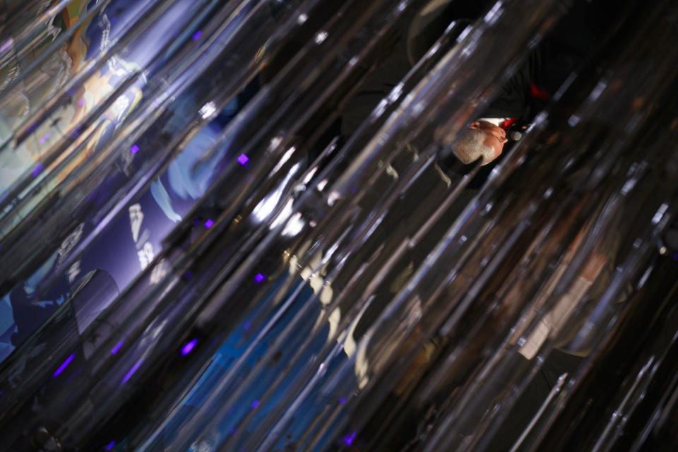 Vice President Mike Pence is reflected in a ceiling chandelier as he makes a speech about the U.S. and China relations Thursday, Oct. 24, 2019, at the Wilson Center's inaugural Frederic V. Malek Public Service Leadership Lecture, in Washington. (AP Photo/Jacquelyn Martin)