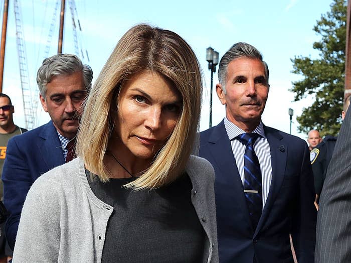 Lori Loughlin and her husband, Mossimo Giannulli (right), leave the federal courthouse in Boston on Aug. 27, 2019.