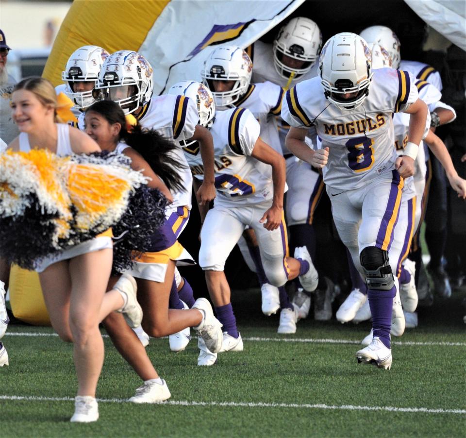 Munday runs out on to the field before their game against Petrolia on Sept. 24 in Petrolia.