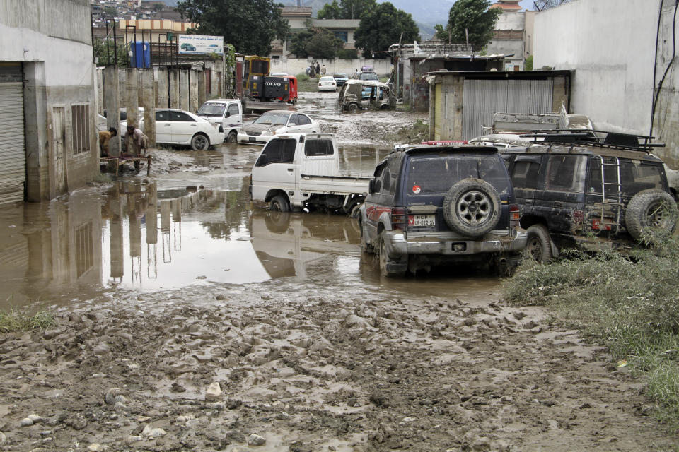 Vehicles on the flooded road in Mingora, the capital of Swat valley in Pakistan, Saturday, Aug. 27, 2022. Officials say flash floods triggered by heavy monsoon rains across much of Pakistan have killed nearly 1,000 people and displaced thousands more since mid-June. (AP Photo/Naveed Ali)